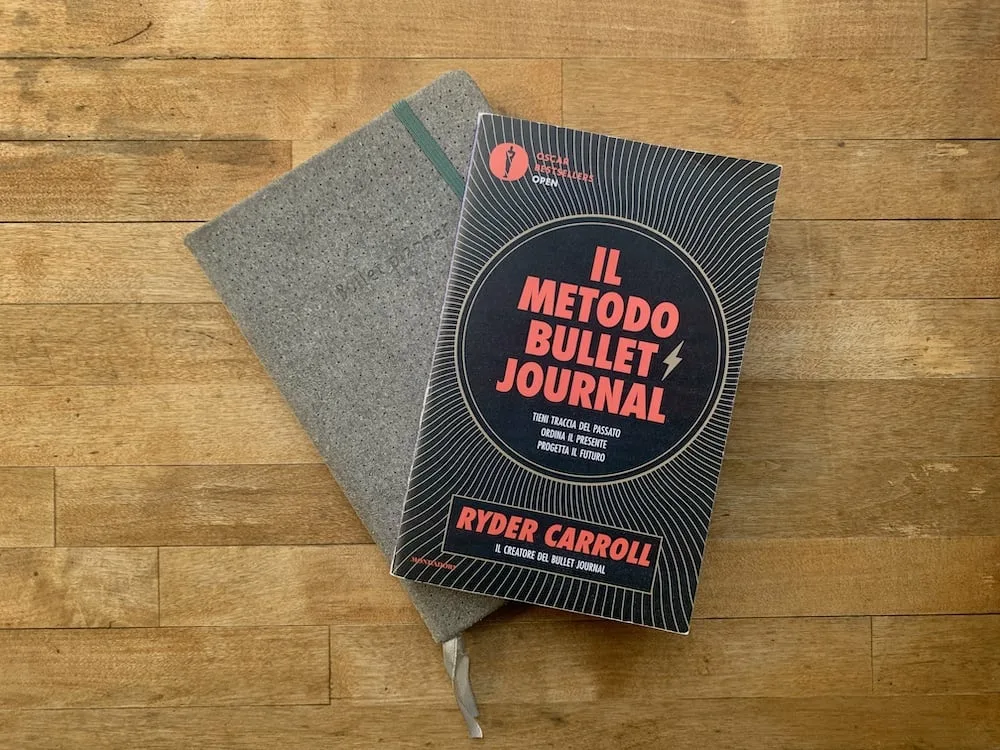 the bullet journal method book and a notebook jpg